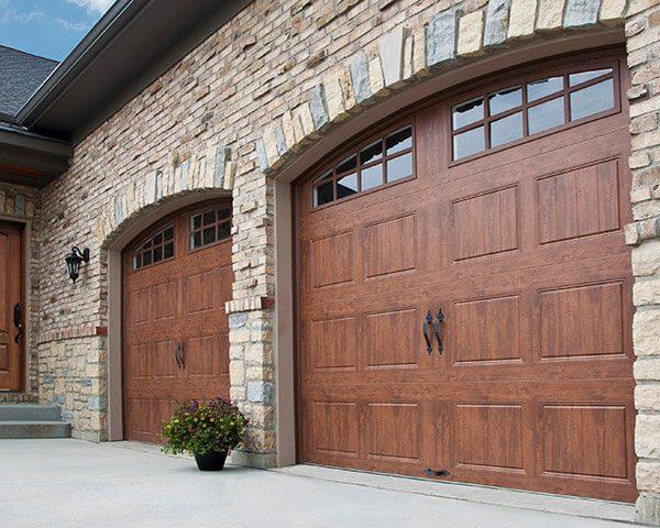 Wood garage doors on brick house